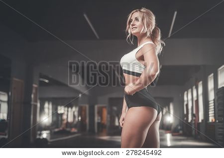 Strong Sexy Athletic Young Woman Working Out In Gym