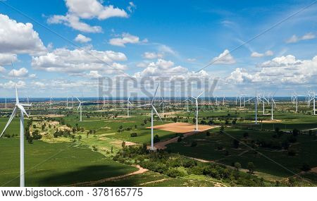 Aerial Landscape Of Windmills Farm With White Sky On Blue Sky At Huai Bong, Dan Khun Thot District, 