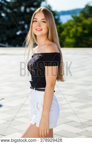 Close up portrait of a young beautiful blonde woman in white shorts