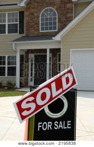 Sold Sign In Front Of Beautiful New Home