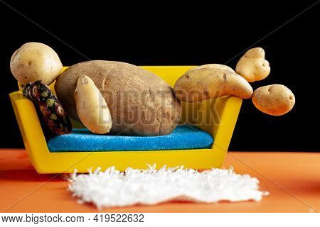 A Quirky Metaphorical Concept Image Showing A Potato Man Lying On A Couch In A Living Room Setting. 