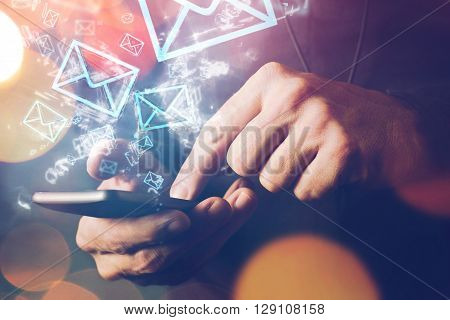 Man sending e-mail message to mailing list contacts using smartphone close up of hands holding phone.