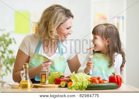 mother and her kid preparing healthy food and having fun