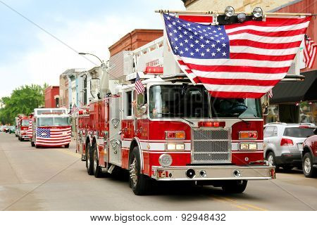 Fire Trucks With American Flags At Small Town Parade