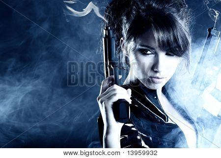 beautiful sexy girl holding gun . smoke background