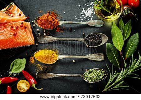 Delicious  portion of fresh salmon fillet  with aromatic herbs, spices and vegetables - healthy food, diet or cooking concept