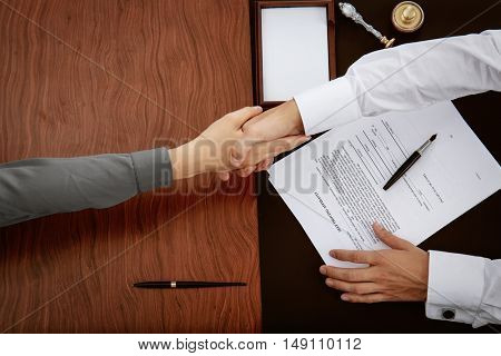 Woman and notary public shaking hands