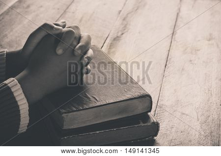 bible book bright christian christianity dark dim finger god hand holding holy home human knowledge learning light male man people person pray prayer read religion religious silence sitting spiritual spirituality study studying table text wood