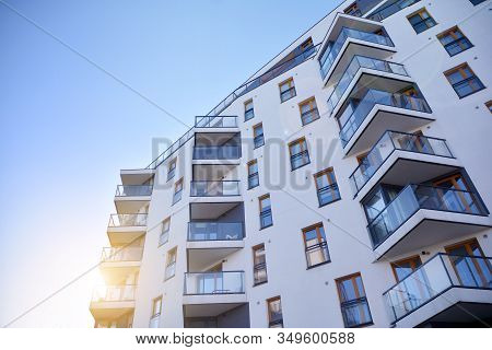 Sun Rays Light Effects On Urban Buildings. Fragment Of Modern Residential Apartment With Flat Buildi