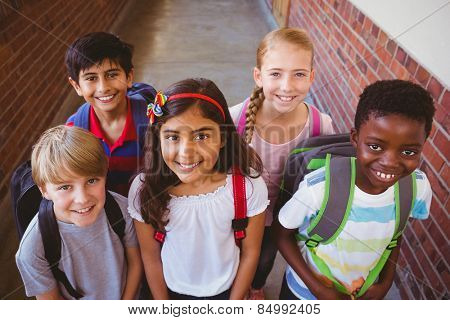 Portrait of smiling little school kids in school corridor