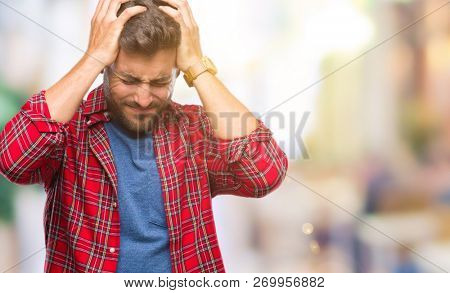 Young handsome man over isolated background suffering from headache desperate and stressed because pain and migraine. Hands on head.