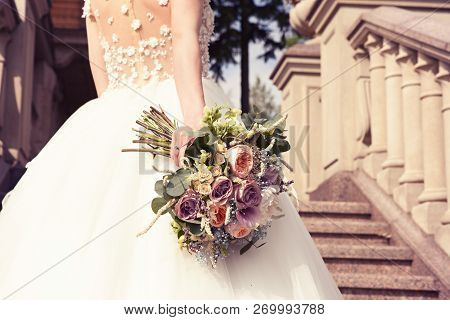 Young Bride In A White Dress With A Beautiful Wedding Bouquet On A Marble Staircase In An Old Castle