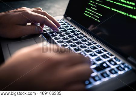 Hacker With Malware Software Code In Computer Screen. Developing Fraud Website. Cybersecurity Attack