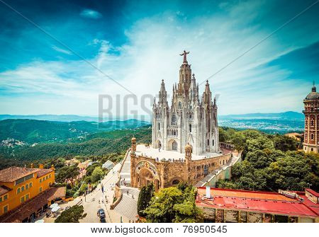 Tibidabo church on mountain in Barcelona with christ statue overviewing the city