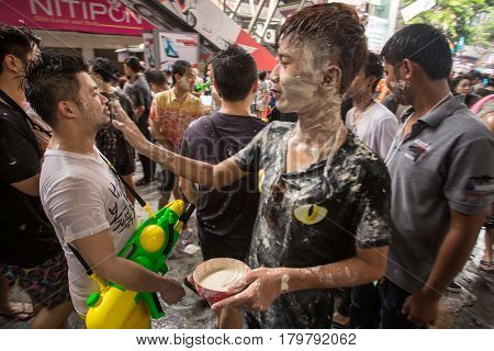 Bangkok, Thailand - April 13, 2014 : The Songkran festival or Thai New Year's festival on Silom street in Bangkok, Thailand.