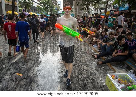 Bangkok, Thailand - April 13, 2014 : The Songkran festival or Thai New Year's festival on Silom street in Bangkok, Thailand.