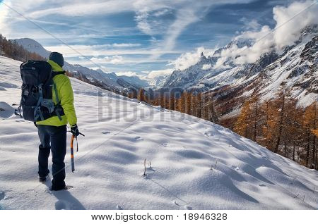 Exploration concept: a lonely hiker in the wilderness. Mont Blanc massif, Val Ferret, Courmayeur, Valle d'aosta, Italy.