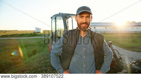 Portrait Of Young Caucasian Handsome Happy Man Farmer Standing In Field And Smiling To Camera. Big T