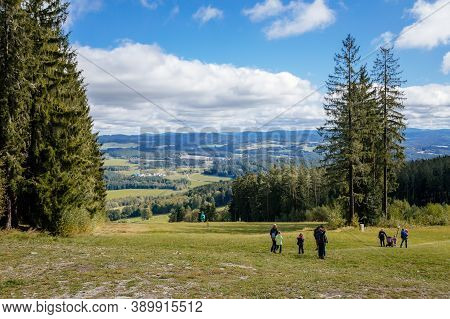 Tourists Walking In The Mountains. The Trees Of Sumava National Park Near The Treetop Walkway (stezk