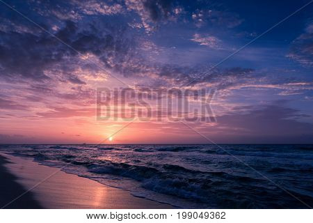 Nature in twilight period Sunrise or Sunset over the sea with beach chair. Sea view from tropical beach with purple sky. Summer beach with blue sea water and purple sky. Vintage retro sea scape.