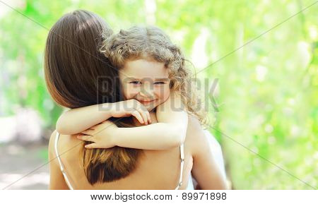 Mother's Day, Family, Childhood And People Concept - Happy Daughter Hugging Mother In Warm Sunny Sum