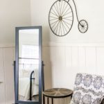 Mirror and seating area in bedroom