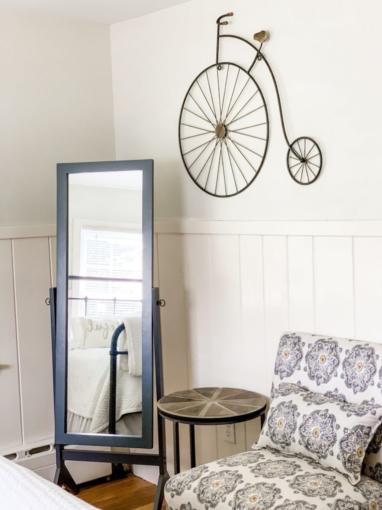 Mirror and seating area in bedroom