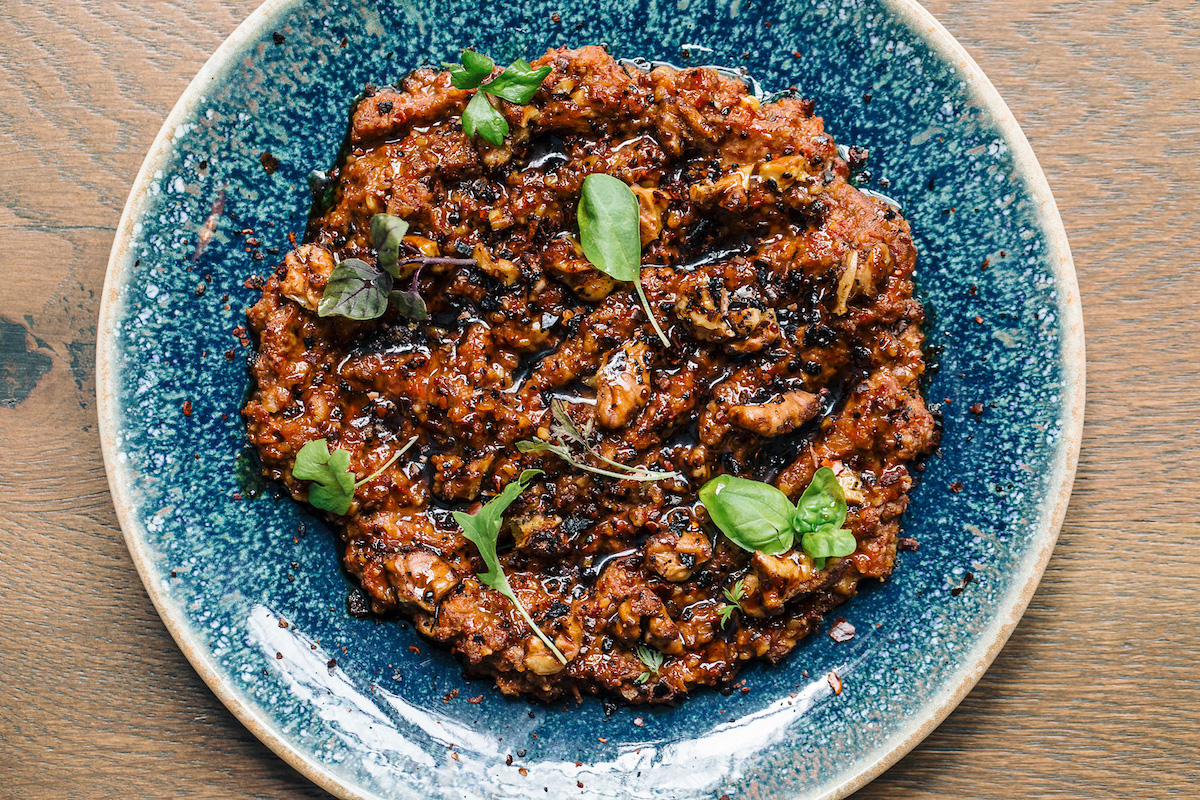 muhammara spread presented on turquoise plate