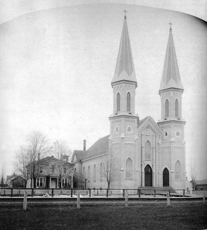 Twin steeples of St. Louis Church were finally completed in 1891.  The rectory on the left burned down in 1938.