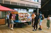 A group of people gathered around the mobile bookshop, talking.