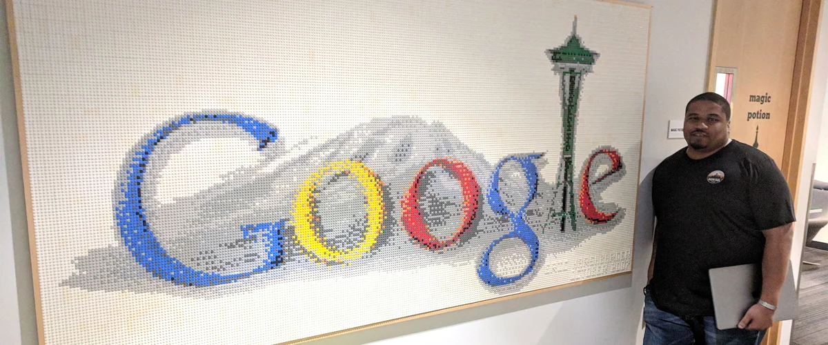 Alex stands next to a Google sign at the Seattle office