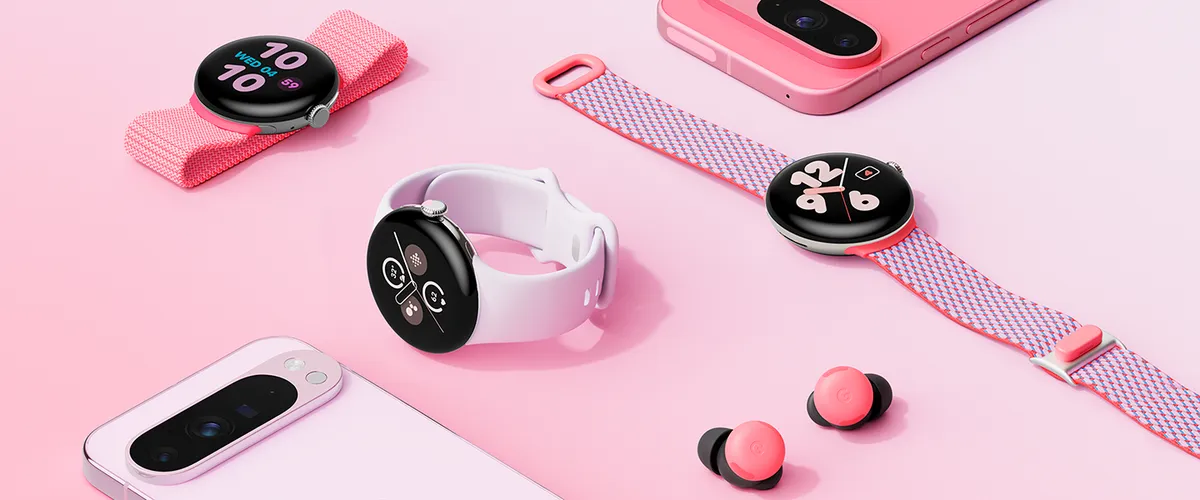 A pink background with pink Google Pixel devices laying across it, including three Pixel Watches with different shades of pink bands, two pink Pixel 9 Pros and pink Pixel Bud Pro 2 buds.