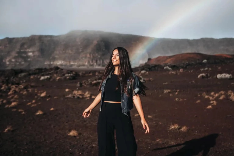 woman standing in front of a rainbow