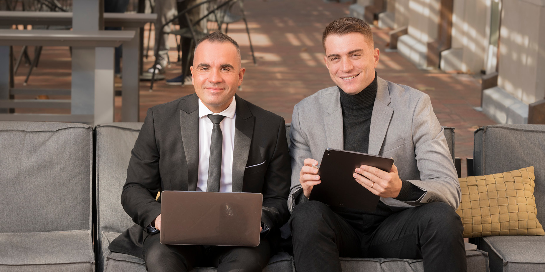 Massimo Ruzza and Gabe Giusti use laptop computers.