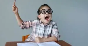 an excited little girl with an empty notebook