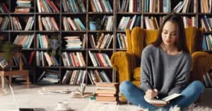 a girl sits in front of a chair and plans a story