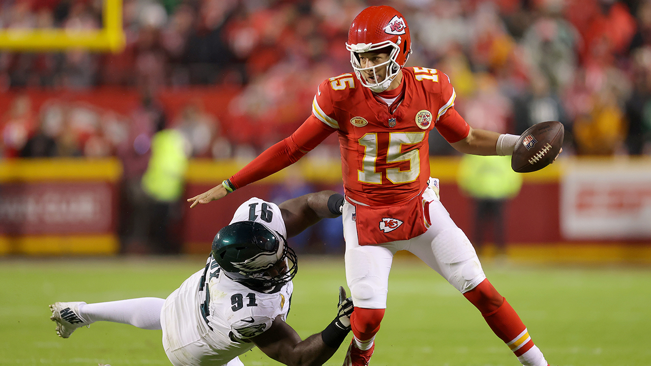 KANSAS CITY, MISSOURI - NOVEMBER 20: Patrick Mahomes #15 of the Kansas City Chiefs gets away from Fletcher Cox #91 of the Philadelphia Eagles in the first half  at GEHA Field at Arrowhead Stadium on November 20, 2023 in Kansas City, Missouri.