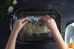 adding foil to the exposed bones on the standing rib roast