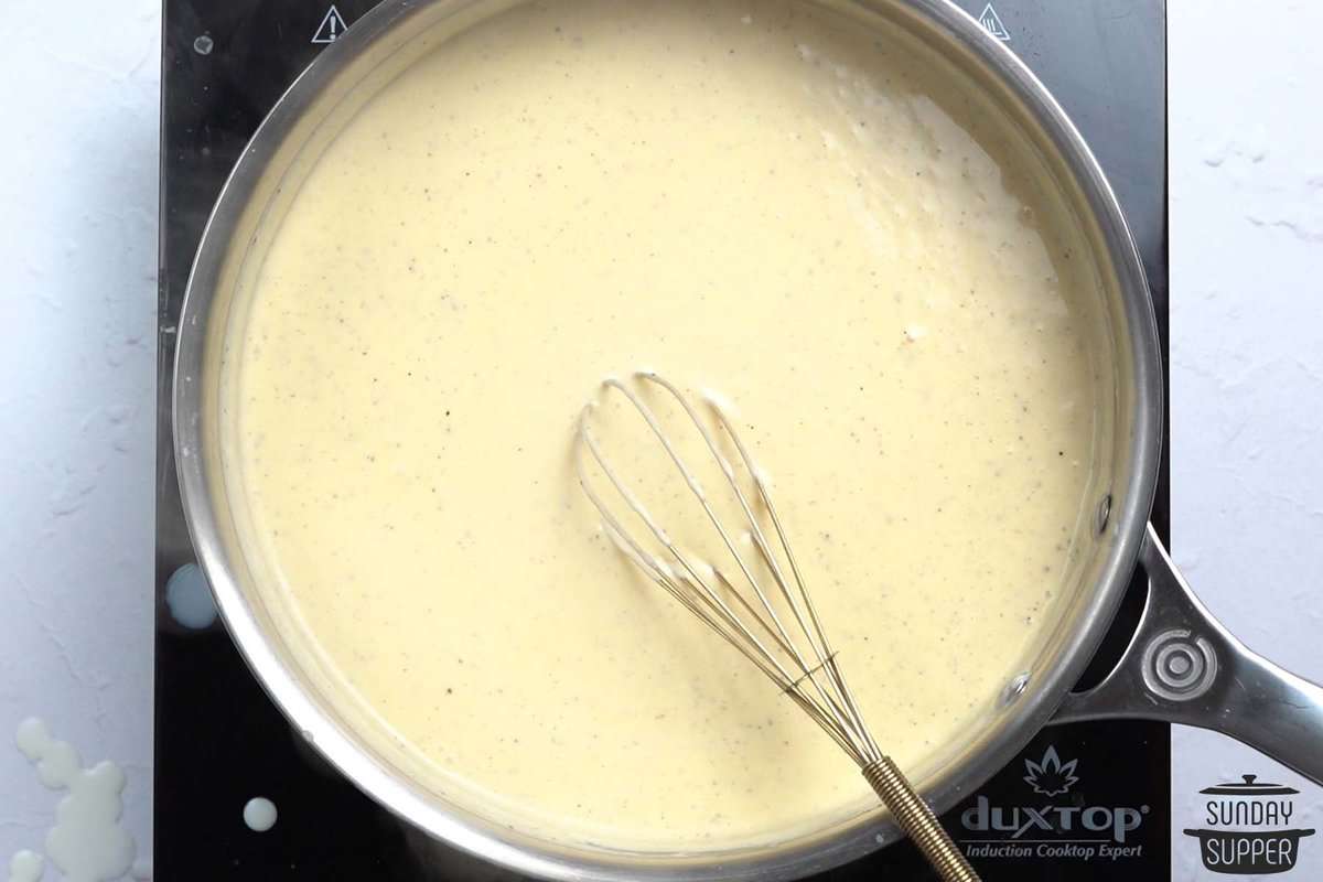 mixing cheese sauce for scalloped potatoes