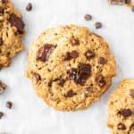 A close up shot of a vegan oatmeal cookie sprinkled with flakes of sea salt.