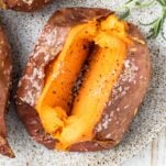 A baked sweet potato with a crispy skin.