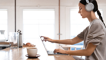 A woman using Surface Laptop on a desk