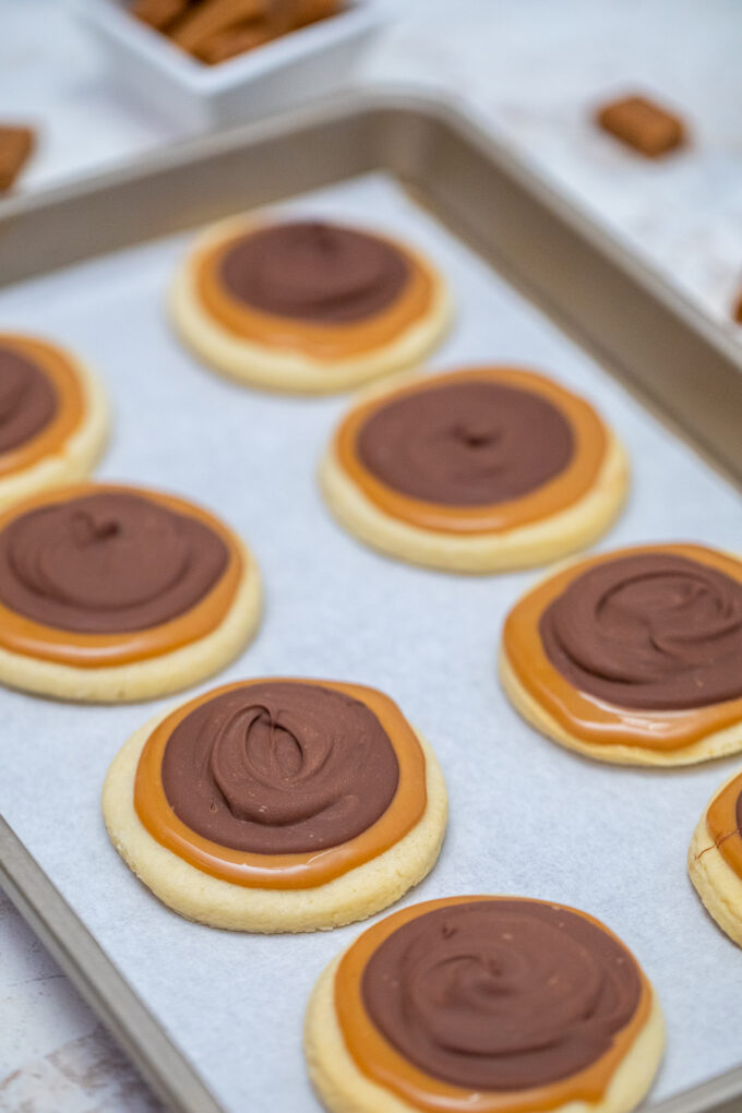 twix cookies are arranged in two rows on a baking sheet