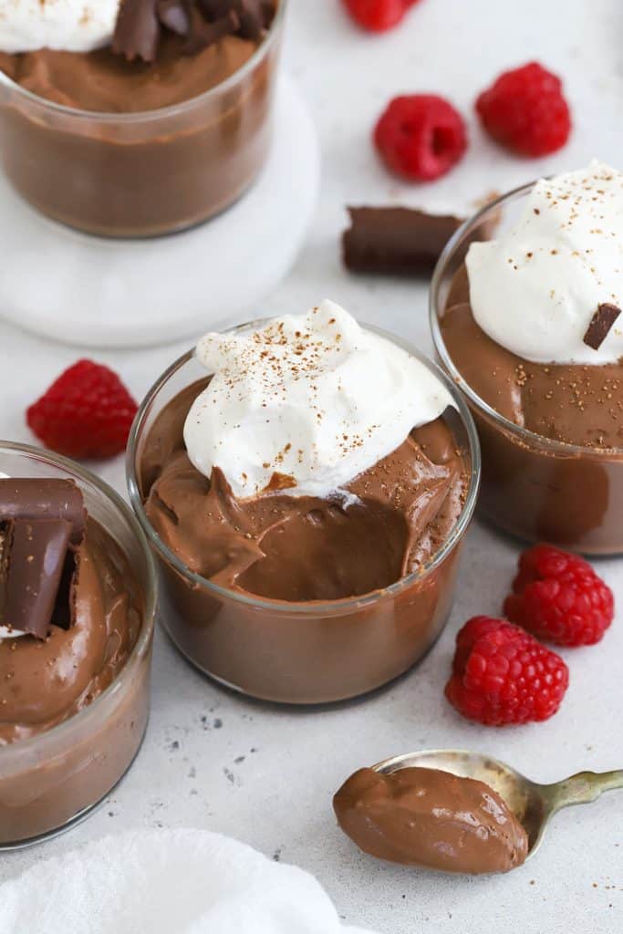 homemade gluten-free chocolate pudding topped with whipped cream