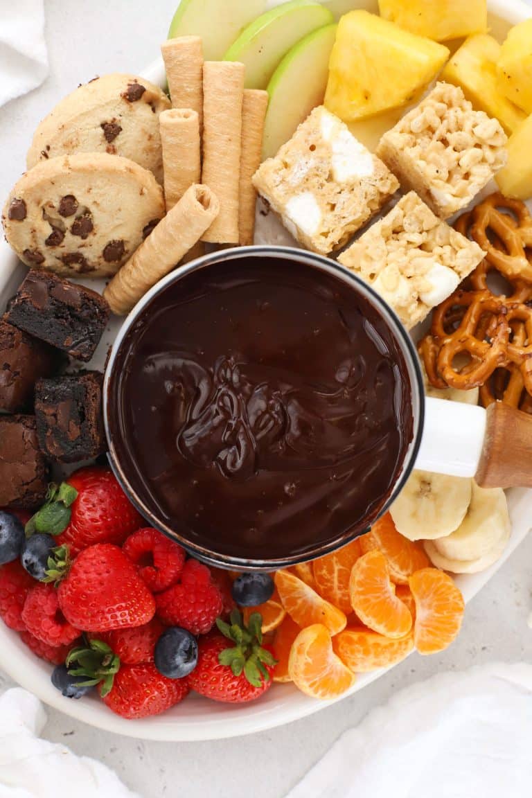 gluten-free chocolate fondue surrounded by fresh fruit and gluten-free dippers