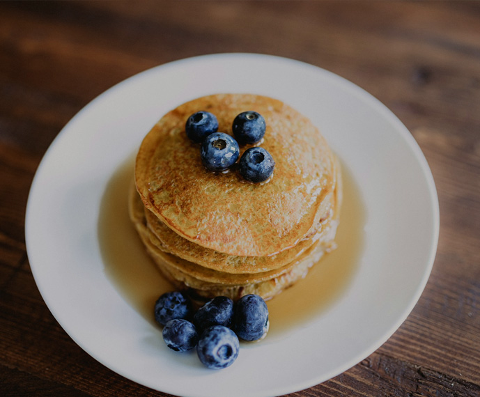 a stack of pancakes with blueberries on top