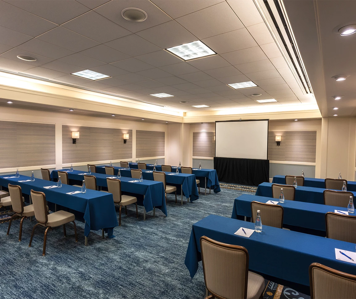 a room with blue tables and chairs