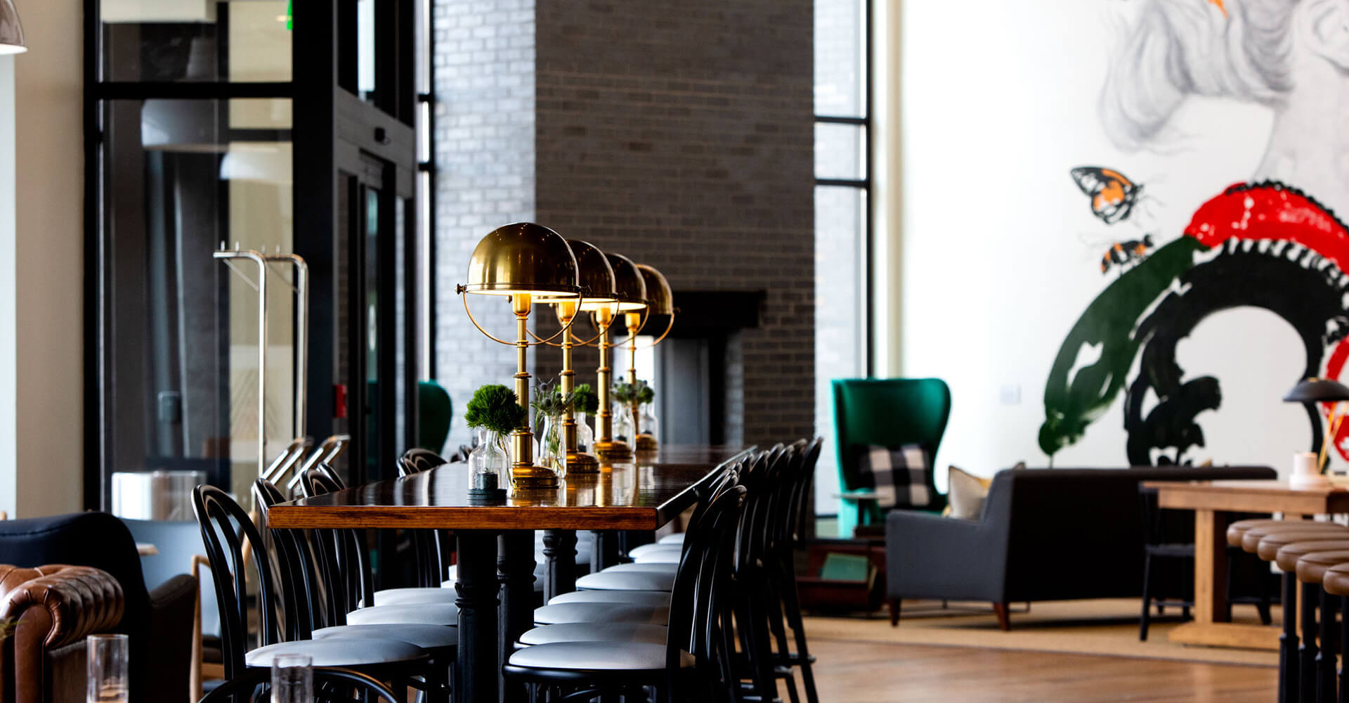 long rectangular wooden table in the middle of the restaurant