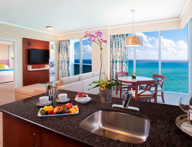 suite with full kitchen and living room suite looking at the ocean