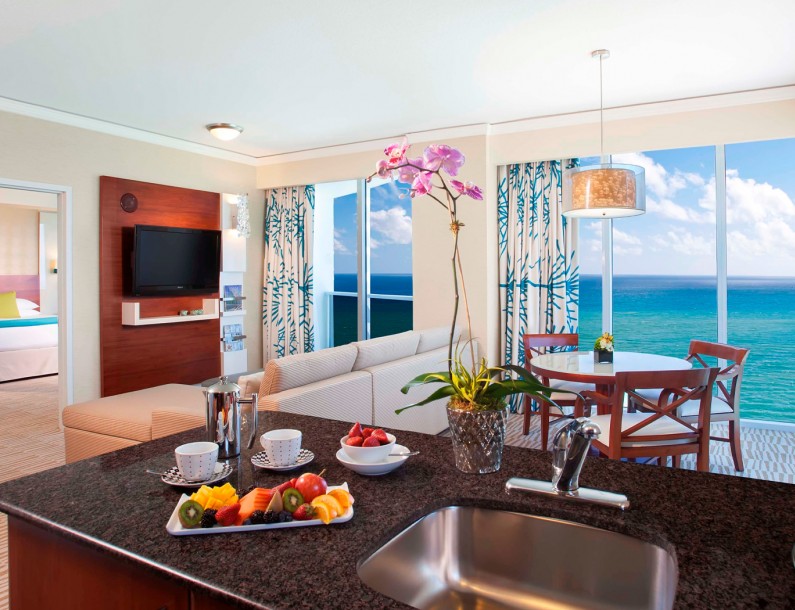 Trump international two bedroom suite living room and full kitchen with an ocean view